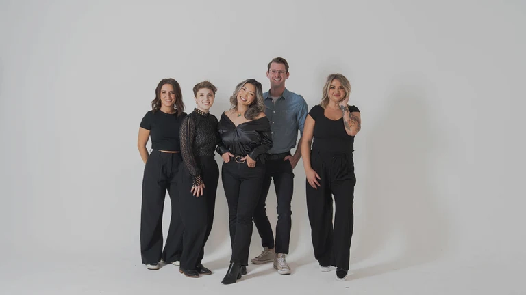 The team at LilyFloralCollective standing together for a group photo in front of a white backdrop.
